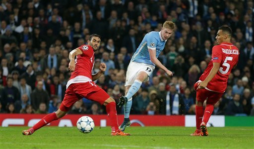 Manchester City's Kevin De Bruyne centre shoots and score his sides second goal during the Champions League Group D soccer match between Manchester City and Sevilla at the Etihad Stadium Manchester England Wednesday Oct. 21 2015. (AP