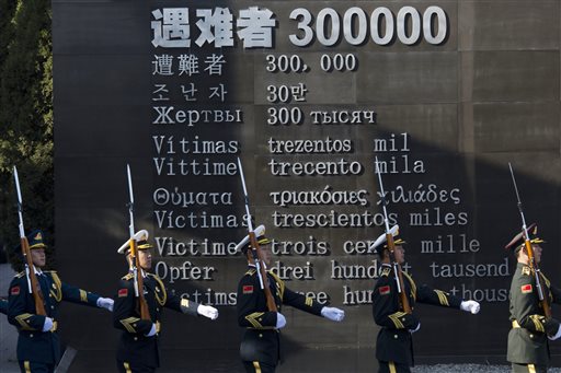 Chinese honor guard members march past the words'Victims 300000 during a ceremony to mark China's first National Memorial Day at the Nanjing Massacre Memorial Hall in Nanjing in eastern China's Jiangsu