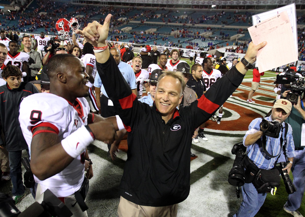 111029 Jacksonville Fl Georgia coach Mark Richt and linebacker Alec Ogletree celebrate their 24-20 win over at Ever Bank Field Saturday afternoon in Jacksonville Fl