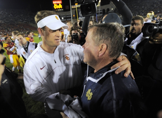 Former Southern California football coach Lane Kiffen left shakes hands with Notre Dame coach Brian Kelly after a game in 20012 in Los Angeles