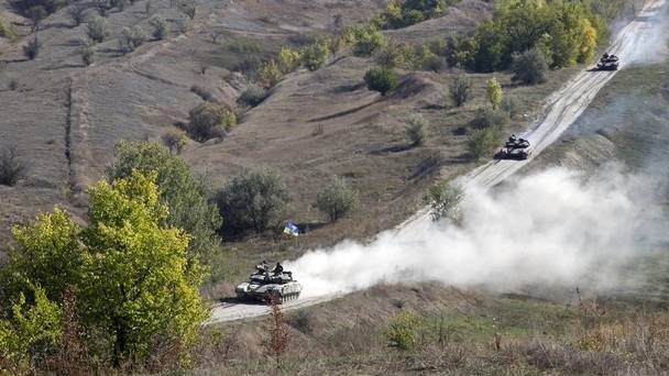 Ukrainian army tanks roll from the front line near the village of Krymske in the Luhansk region of eastern Ukraine