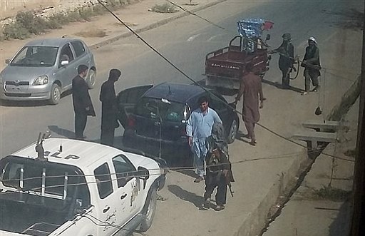 Taliban fighters search passengers and civilian vehicles in a check point in Kunduz city north of Kabul Afghanistan Tuesday Sept. 29 2015. Taliban gunmen fanned out in full force Tuesday across a key Afghan city they captured the day before as the U