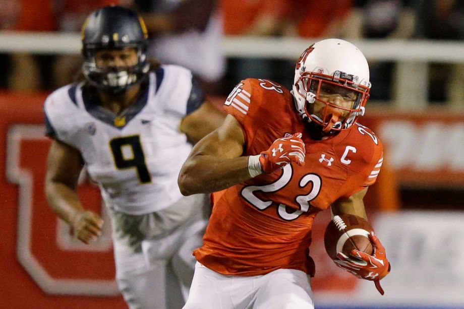 Utah running back Devontae Booker carries the ball while being pursued by California defensive tackle James Looney in the first half during an NCAA college football game Saturday Oct. 10 2015 in Salt Lake City