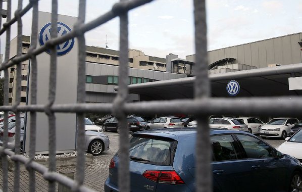 Germany's car company Volkswagen is displayed at the building of a company's retailer in Berlin Germany. Germany's motor transport agency is ordering a mandatory recall of Volkswagen cars sold with software