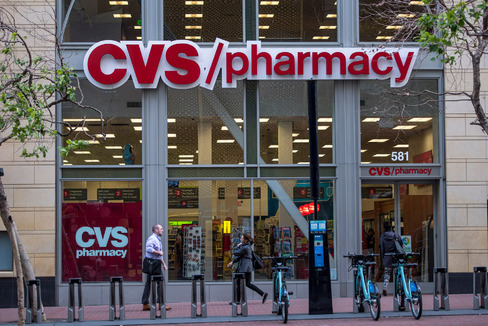 Pedestrians walk past a CVS Health Corp. store in San Francisco California U.S. on Thursday