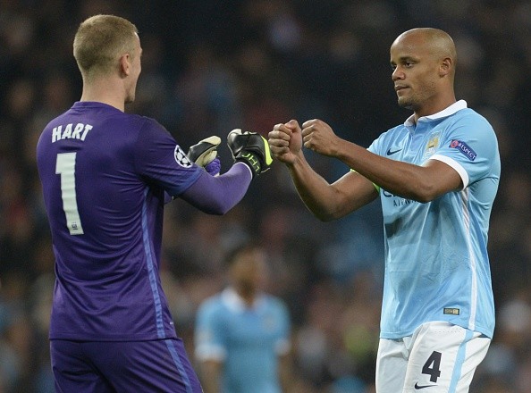 Vincent Kompany celebrates City’s Champions League victory against Sevilla with Joe Hart