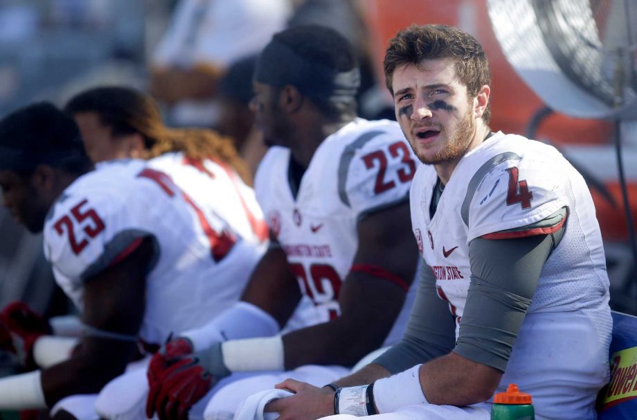 Washington State quarterback Luke Falk right watches from the bench during the second half of an NCAA college football game against California Saturday Oct. 3 2015 in Berkeley Calif. California won the game 34-28