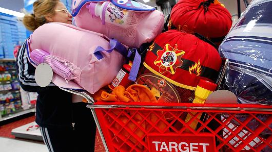 Shopper Maria Montoya of Eagle Rock California looks for more bargains as she wheels her cart piled high with Christmas gifts through her local Target store