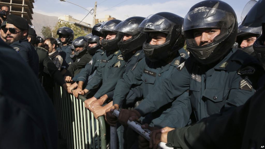 Iranian police officers protect the Saudi Arabian Embassy during a gathering of protesters blaming the Arab country for a deadly stampede that killed more than 700 pilgrims in Tehran Iran Sept. 27 2015