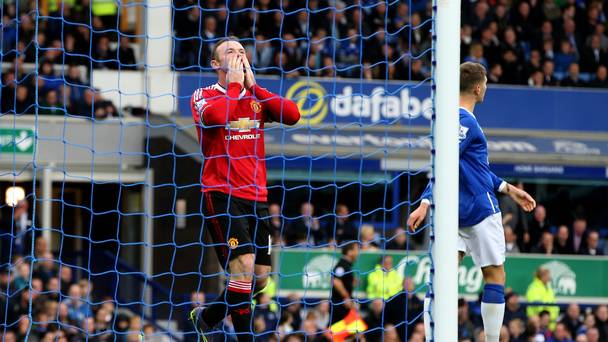 Wayne Rooney tempers his celebration after scoring at Everton