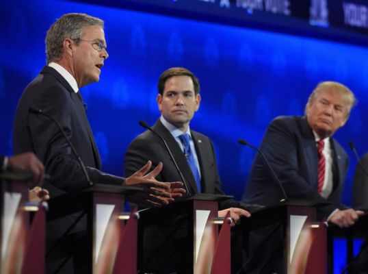 Marco Rubio center and Jeb Bush left argue