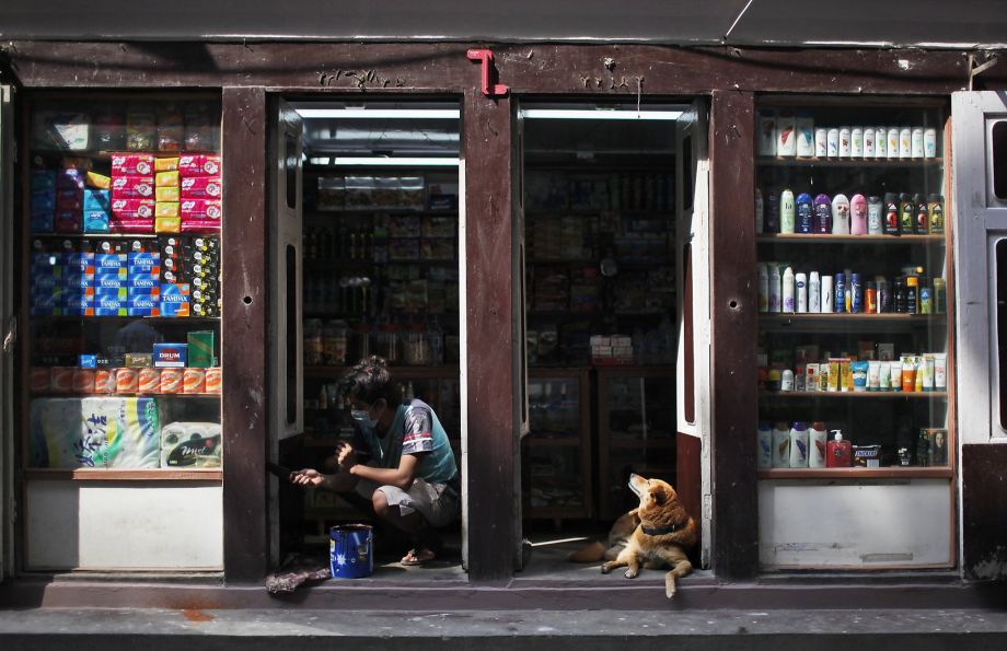 A man paints a shop in Thamel the tourist hub in Kathmandu lined with stores for trekking gear and souvenirs