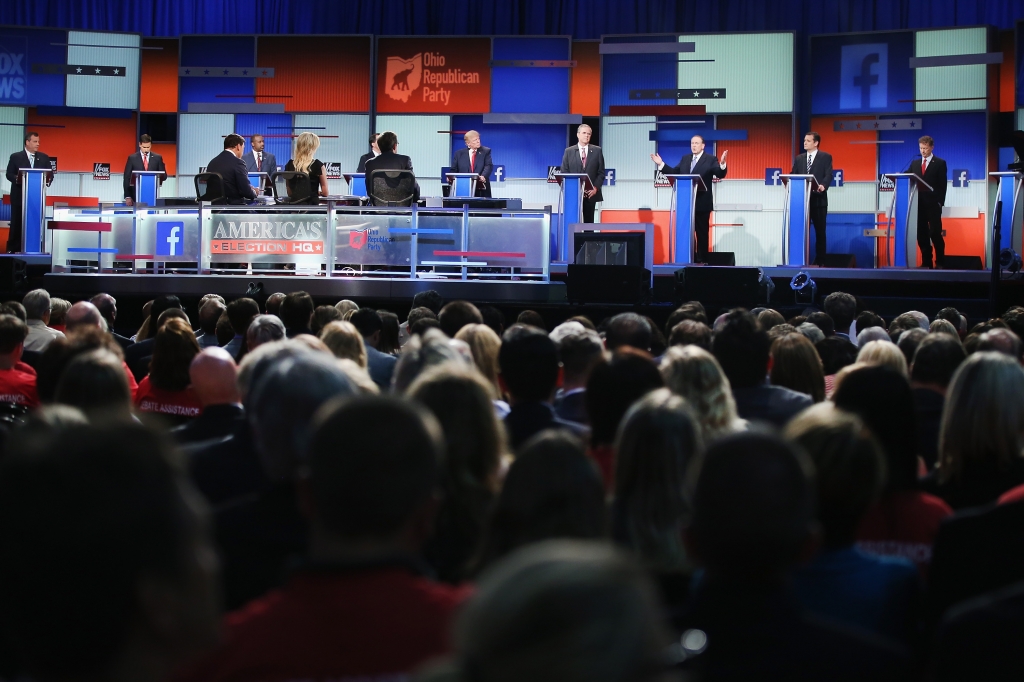 Guests watch Republican presidential candidates speak during the first Republican presidential debate hosted by Fox News and Facebook at the Quicken Loans Arena