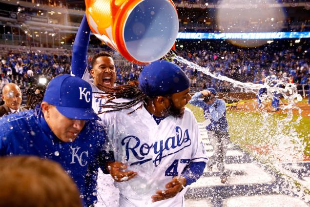 KANSAS CITY MO- OCTOBER 28 Salvador Perez #13 of the Kansas City Royals douses Johnny Cueto #47 of the Kansas City Royals after defeating the New York Mets 7-1 in Game Two of the 2015 World Series at Kauffman Stadium