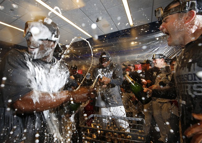 New York Yankees starting pitcher Luis Severino center sprays teammates as the Yankees celebrated their 4-1 win over the Boston Red Sox that allowed them to clinch a wild card berth in the playoffs after a baseball game in New York Thursday Oct. 1 20