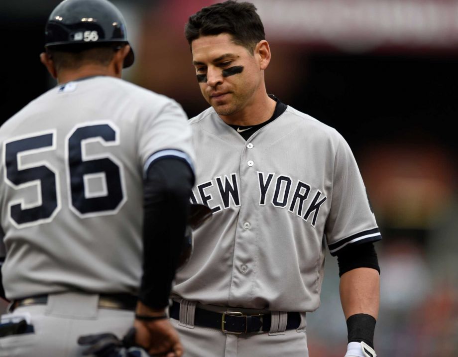 New York Yankees Jacoby Ellsbury right gives his helmet to first base coach Tony Pena after grounding out with two on in the fourth inning of a baseball game against the Baltimore Orioles in Baltimore Sunday Oct. 4 2015