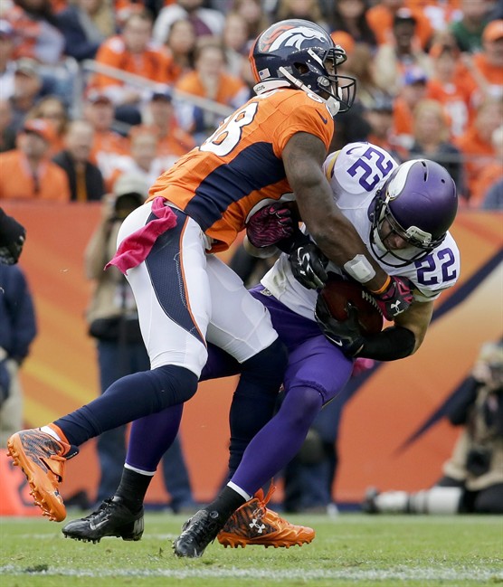 Minnesota Vikings free safety Harrison Smith right intercepts a pass intended for Denver Broncos wide receiver Demaryius Thomas during the second half of an NFL football game Sunday Oct. 4 2015 in Denver