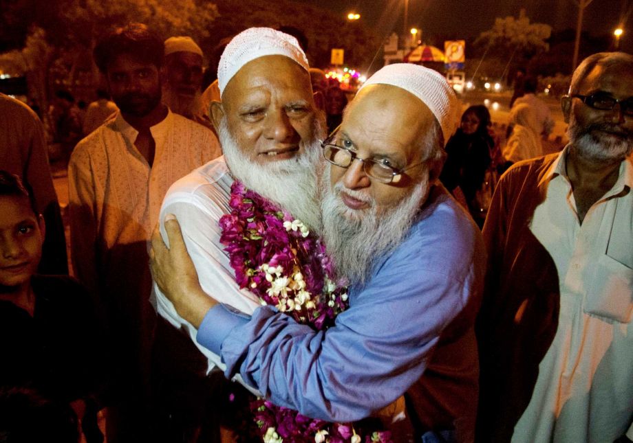 A Pakistani man receives his family member who returned from Saudi Arabia after the hajj pilgrimage at Karachi airport Pakistan Monday Sept. 28 2015. Pakistan's minister for religious affairs says authorities have tracked down 217 Pakistanis who went