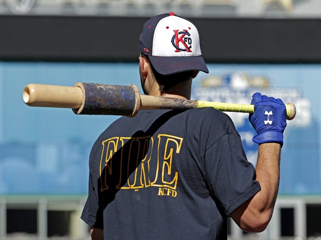 Kansas City Royals Eric Hosmer wears Kansas City Fire Department apparel as he waits to bat during baseball practice Tuesday