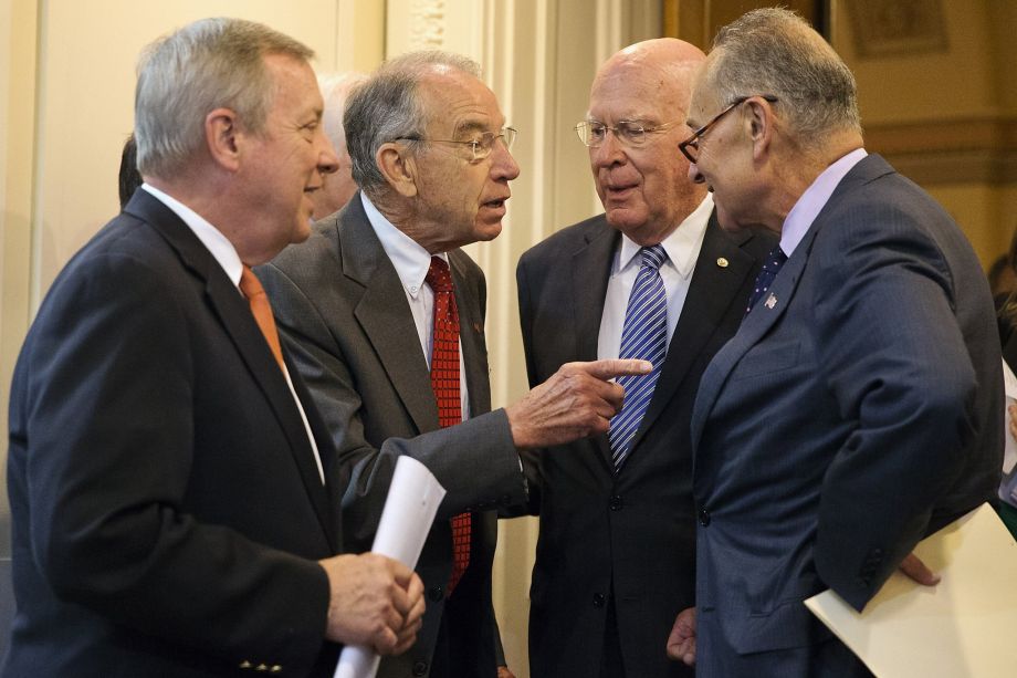 Senate Judiciary Chairman Sen. Charles Grassley R-Iowa talks with fellow senators before a recent news conference on criminal justice reform