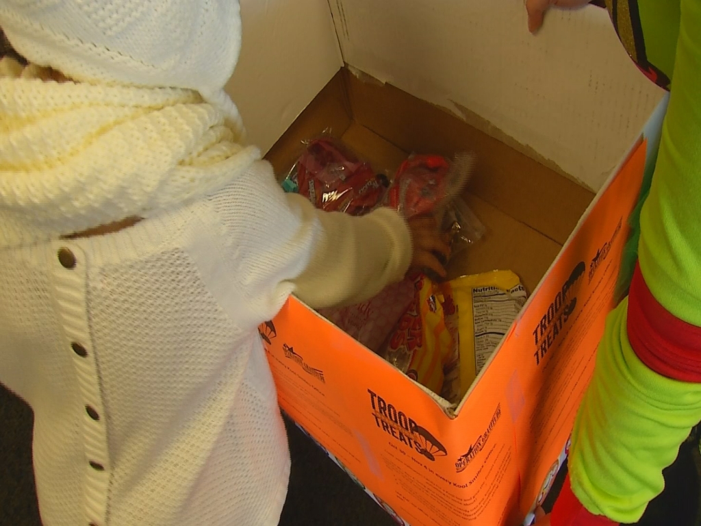 4-year-old Mary Powell exchanges some of her Halloween candy for a toy at the Kool Smiles office in Columbia Friday