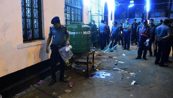 A Bangladeshi police officer collects forensic evidence after a series of blasts rocked Dhaka earlier this month