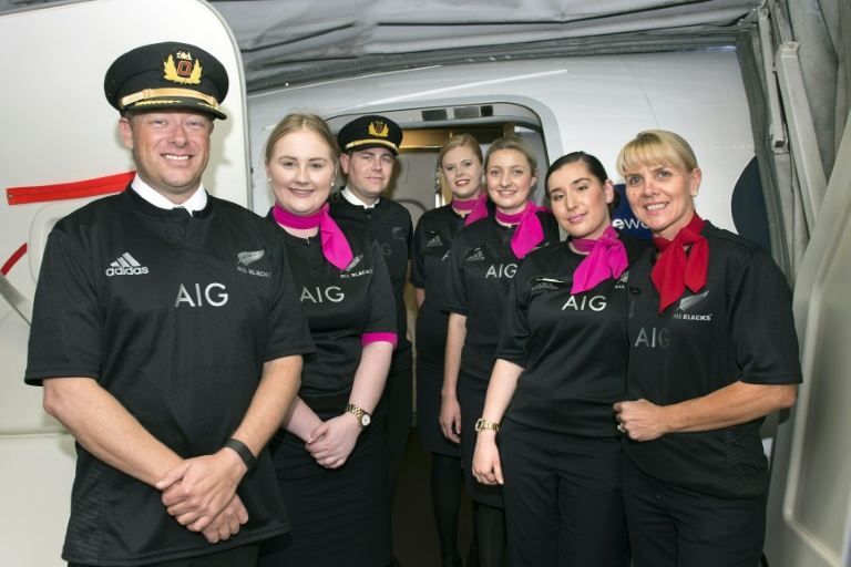 A Qantas flight crew wears the New Zealand All Blacks jerseys for a trans Tasman flight in Sydney