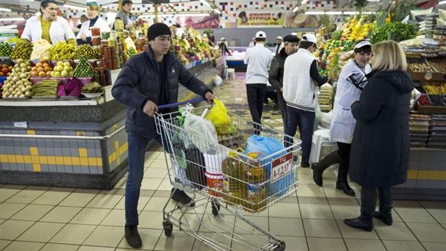 A Russian man pushes a cart with food items at a grocery store in Moscow Russia