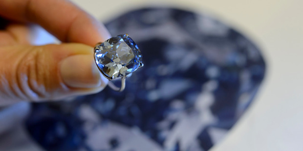 A Southby's employee displays the rare Blue Moon Diamond