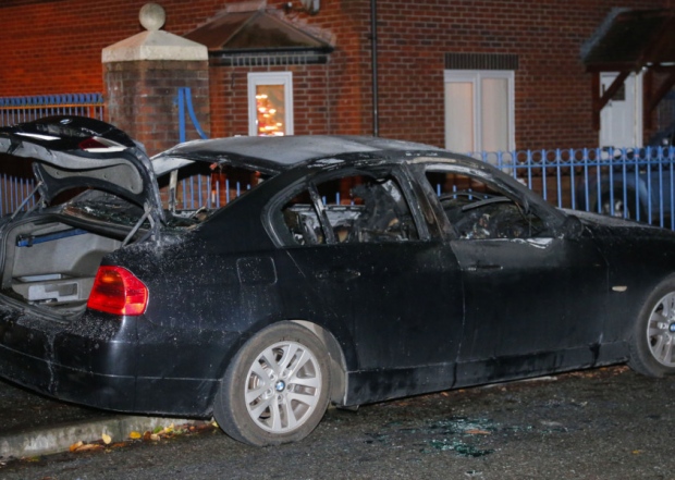 A burnt car found in the Beechmount area following the attempted murder of police officers in Andersonstown