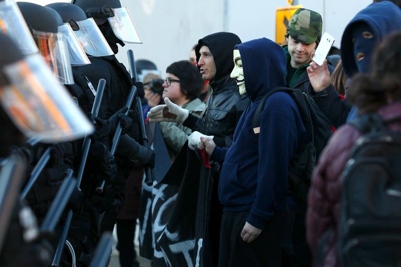 Don't Shoot PDX protesters confronted a row of Portland police during a Black Friday protest during a Nov. 27 march through Northeast Portland