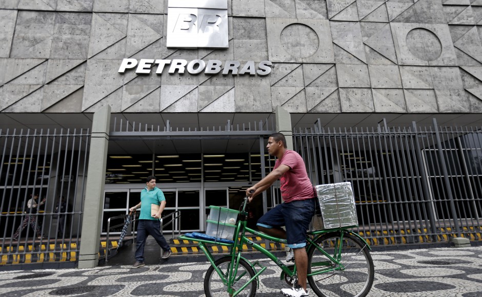 A man rides a bike in front of the Petrobras headquarters in Rio de Janeiro