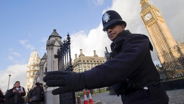 A policeman directs traffic outside the Houses of Parliament