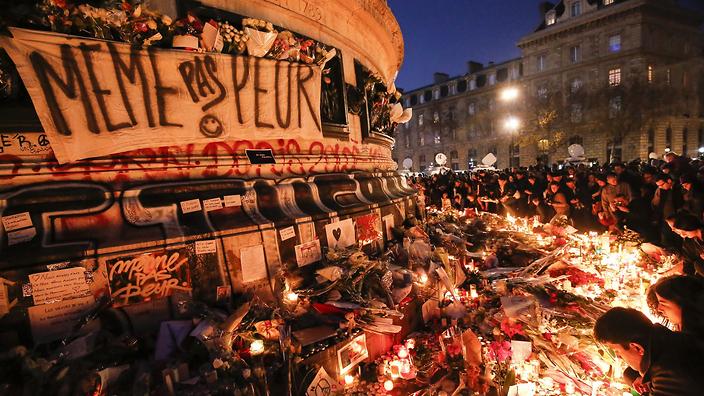 A sign at a memorial at Place de la Republique square in Paris reads in French 'Not Even Afraid&#039