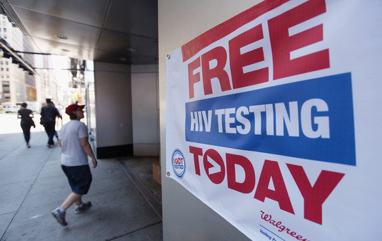 A sign for free HIV testing is seen outside a Walgreens pharmacy in Times Square