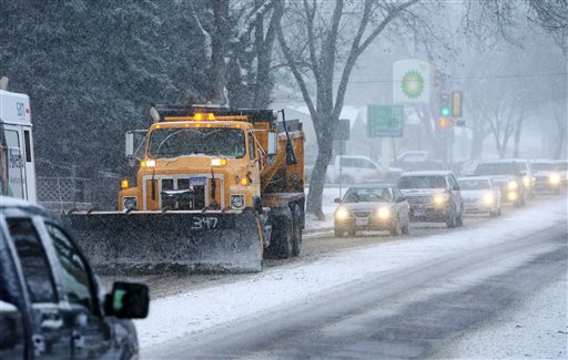 A snow plow heads heads down a street Friday Nov. 20 2015 in Sioux Falls S.D. Morning commuters dealt with slick roads as the first significant snowstorm of the season began developing over parts of the Midwest. Widespread amounts of 4 to 8 inches of