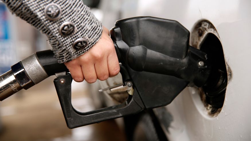 A woman pumps gas at a station in Falls Church Virginia