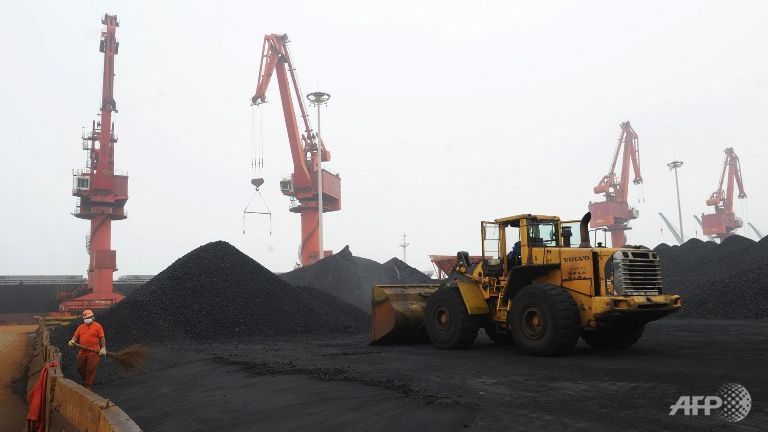 A worker walks at a coal terminal at Lianyungang port in Lianyungang east China's Jiangsu province on Jun 23 2014