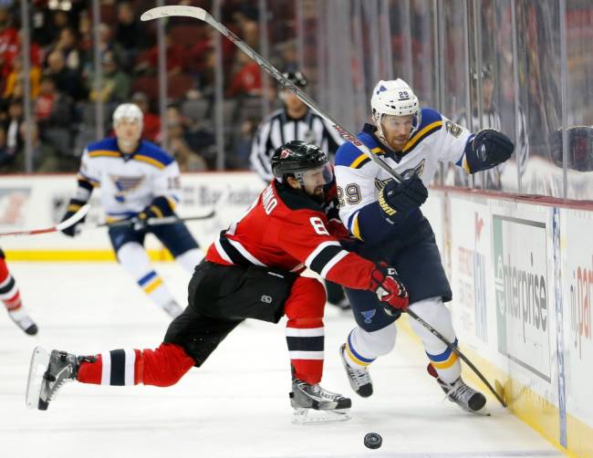 Devils defenseman David Schlemko left checks St. Louis Blues right wing Martin Havlat during the first period Tuesday Nov. 10 2015 in Newark