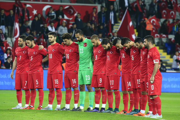 Turkey's players observe the minute of silence prior to their match against Greece