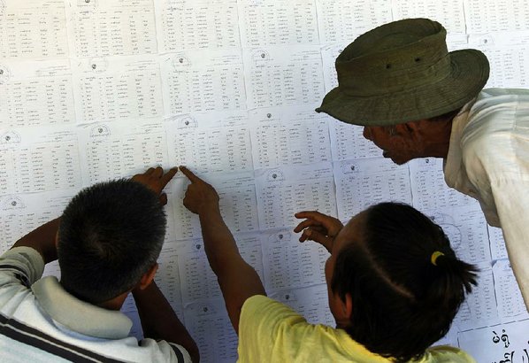 AUNG SHINE OO						Credit AP				People gather around an eligible-voter list Saturday at a township election commission office in Naypyitaw Burma