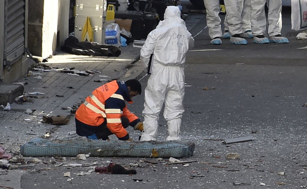 Forensic specialists of the French police work in the northern Paris suburb of Saint Denis in the aftermath of a predawn raid on November 18 that sought people tied to last week's terror attacks