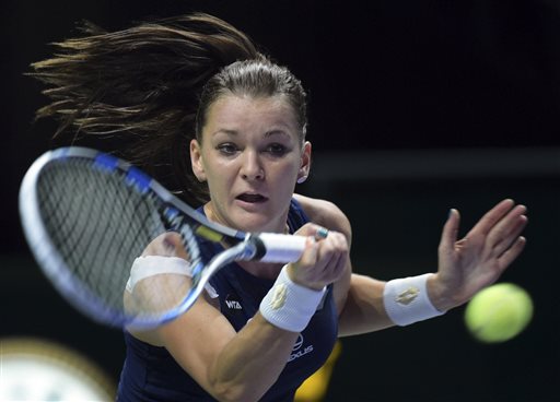 Agnieszka Radwanska of Poland makes a forehand return against Petra Kvitova of Czech Republic during the singles final at the WTA tennis finals in Singapore Sunday Nov. 1 2015