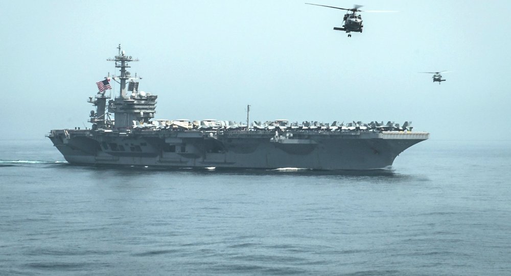 Helicopters fly from the aircraft carrier USS Theodore Roosevelt