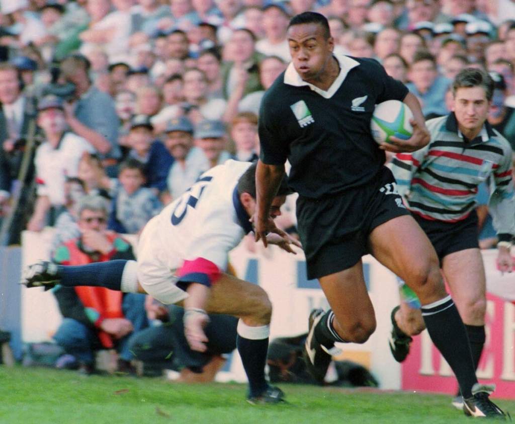 New Zealand All Blacks winger Jonah Lomu runs around England's Will Carling on his way to score the opening try in the Rugby World Cup semifinal at Newlands in Cape Town South Africa