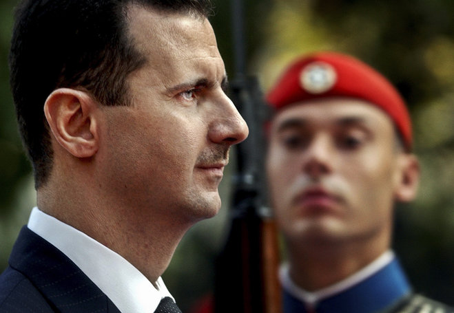 Syrian President Bashar Assad reviews the presidential guard during a welcoming ceremony in Athens. The tide of global rage against the Islamic State group lends greater urgency to ending the jihadis ™