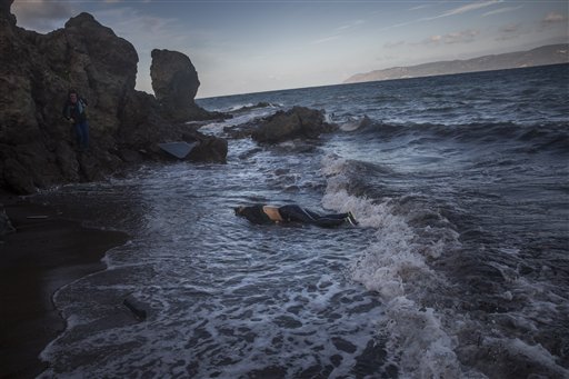 The lifeless body of an unidentified woman on a beach after washing up on the shoreline at the village of Skala on the Greek island of Lesbos on Sunday Nov. 1 2015. Authorities recovered more bodies on Lesbos and the Greek island of Samos Sunday as