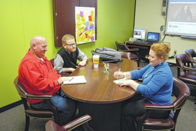 Amanda Bradshaw talks with clients at the Small Business Center