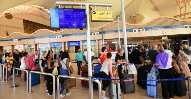 Travelers wait in line at the Sharm el Sheikh airport