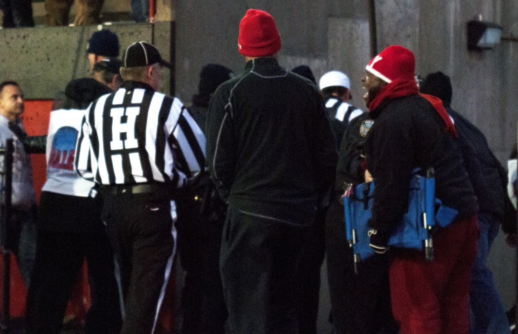 Angry Youngstown State University fans wait in front of the tunnel as the referees from Saturday's game leave the field